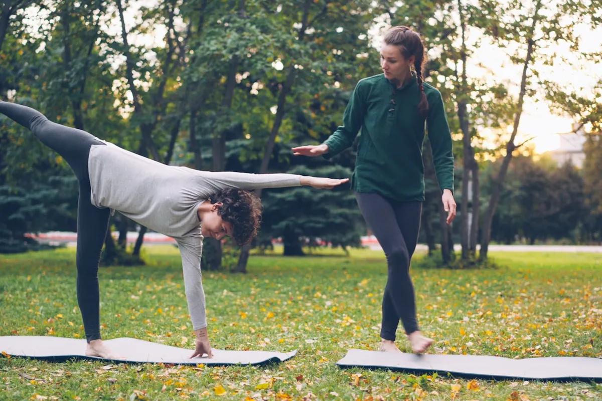 A teacher observing one student in a standing pose