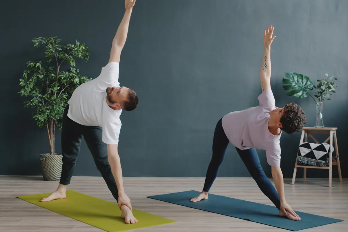 Two students practicing Triangle side by side